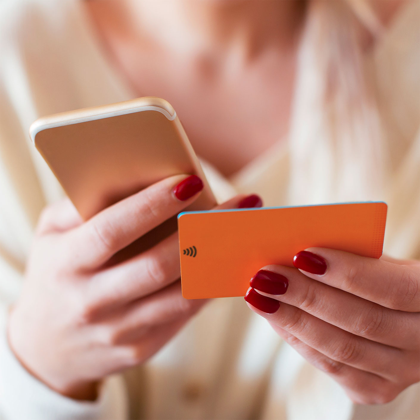 fiserv woman holding an orange credit card